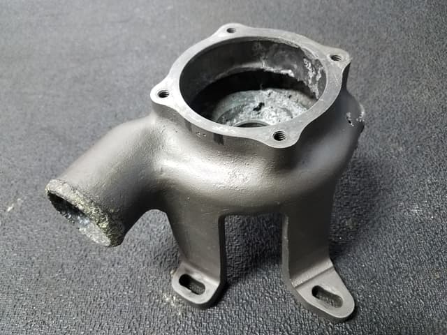 Original water pump showing severe pitting and corrosion