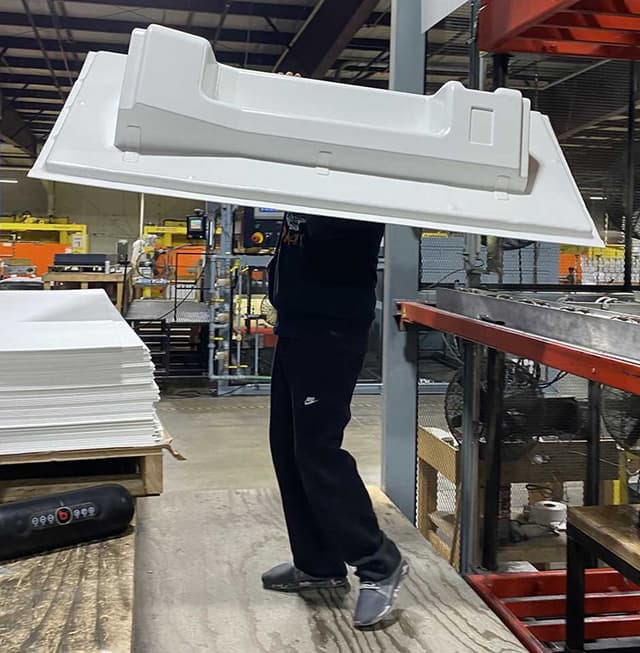 worker carrying duo form thermoform part