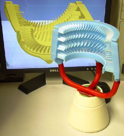 3D printed wax pattern of half of the turbine on sprues
