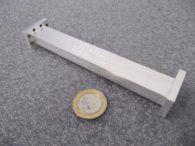 The 3D printed RF filter designed by Airbus Defence and Space consolidates two parts into one and reduces overall mass.  3D printing enables faster production and lower costs.