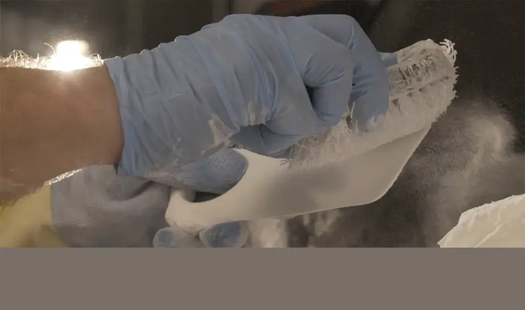 Removing powder from 3D printed insoles by Wiivv Wearables