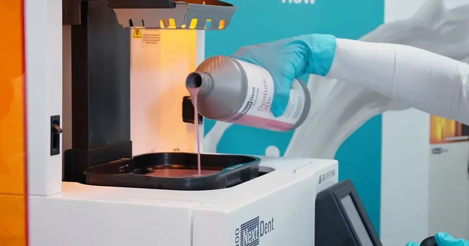 NextDent materials being poured into a NextDent 3D printer