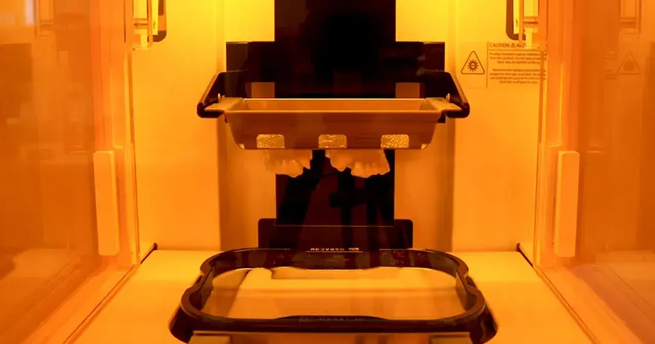 a 3D printer creating a dental part