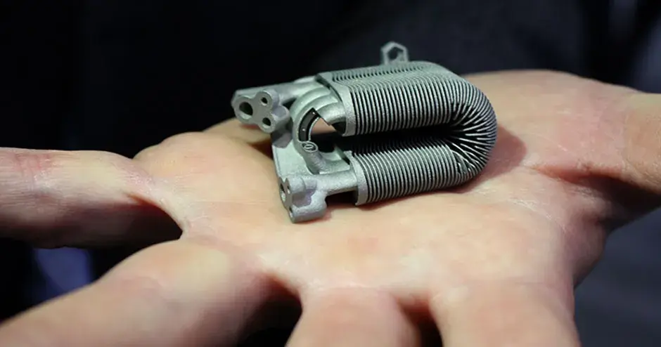 A Lamellar heat exchanger 3d printed in Laserform 316L (B) stainless steel in the palm of a man's hand