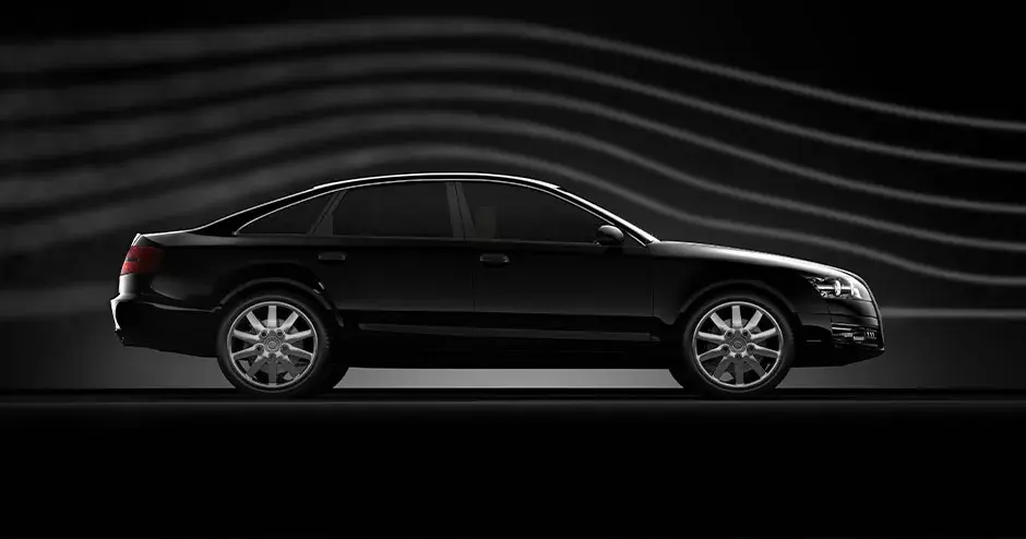 A car with a black background with graphic lines indicating movement and acceleration
