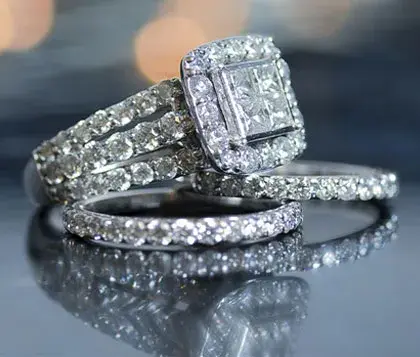ring set including two single bands and a 3-banded ring with a square setting studded with pavé diamonds