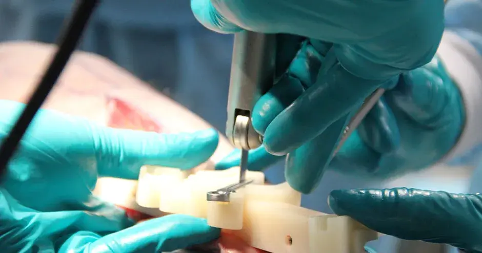 a doctor using surgical instruments on a patient