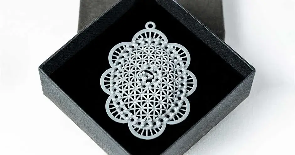 gray casting of middle eastern pendant in a box