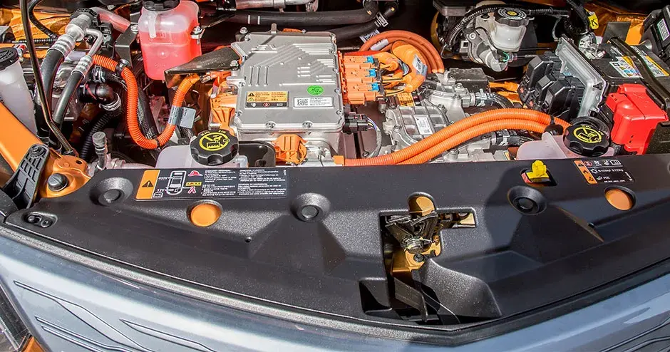 under the hood of an orange electric car, technology of the future