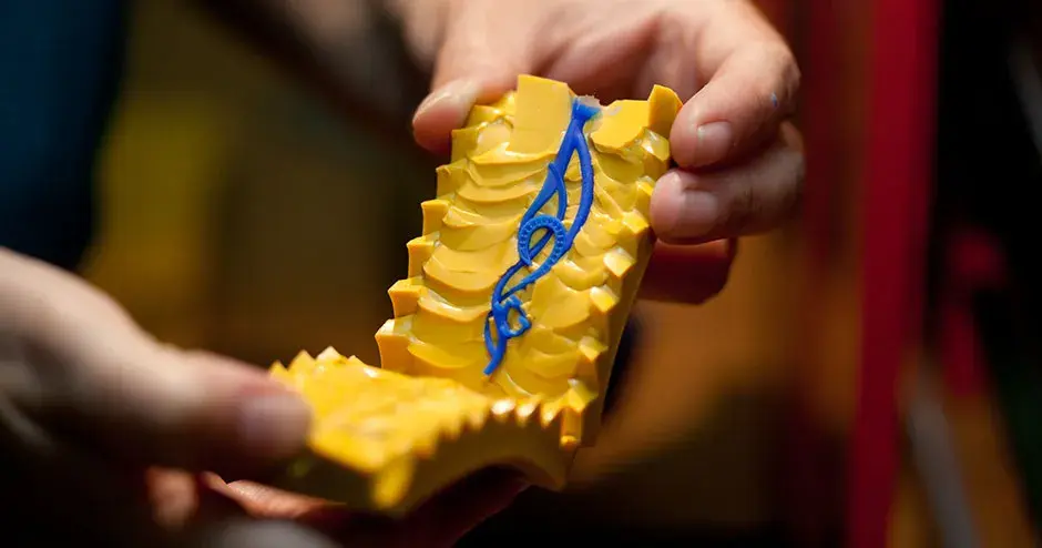 blue wax pendant in a yellow rubber mold