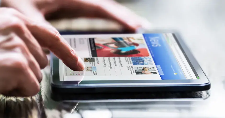 a person reading a tablet with news highlighted