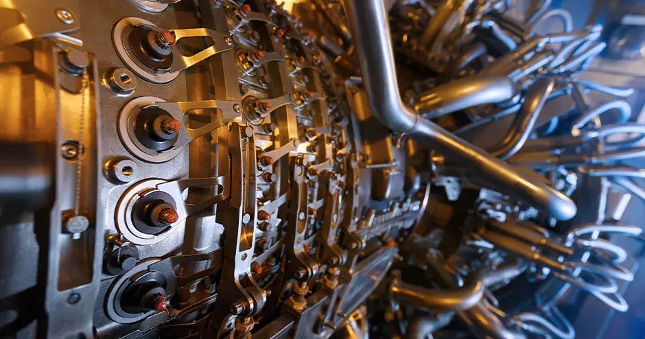 Gas turbine engine of feed gas compressor located inside pressurized enclosure