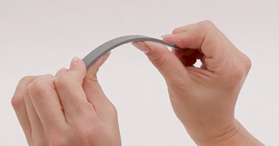 A person bending a part made from Figurre 4 Rigid Gray 
