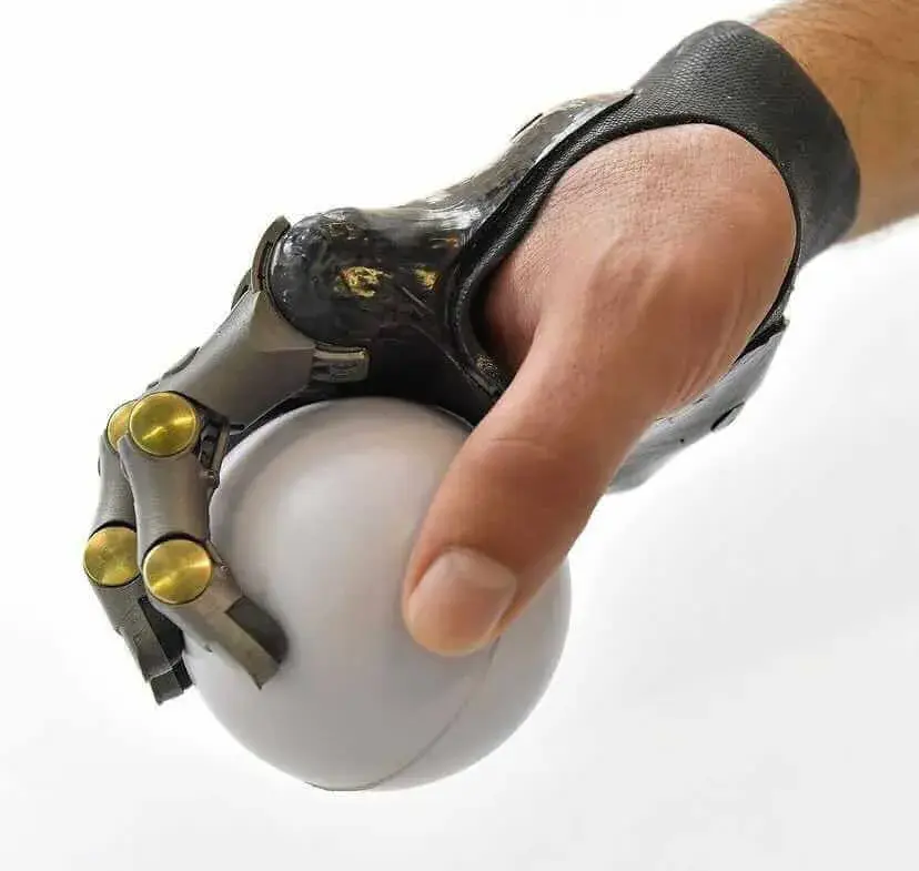 Hand with Point Designs partial prosthetic holding a white ball
