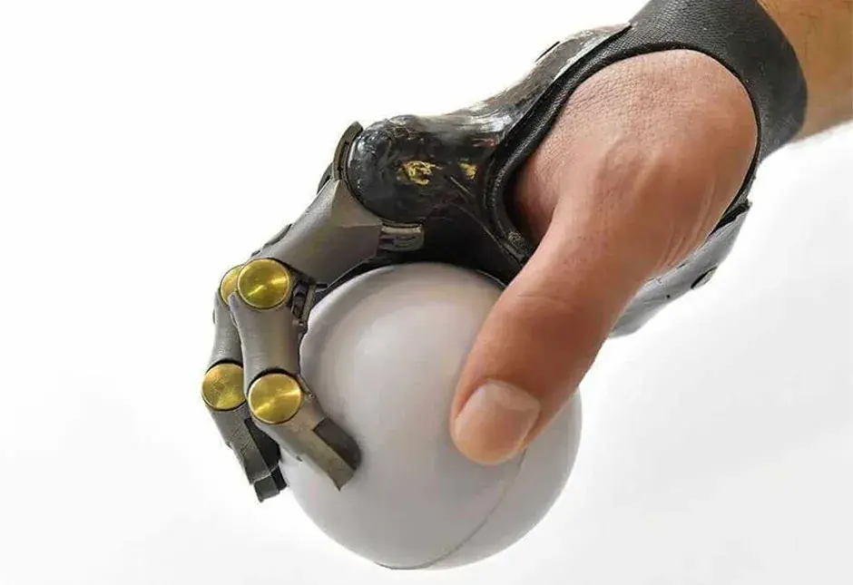 Hand with Point Designs partial prosthetic holding a white ball