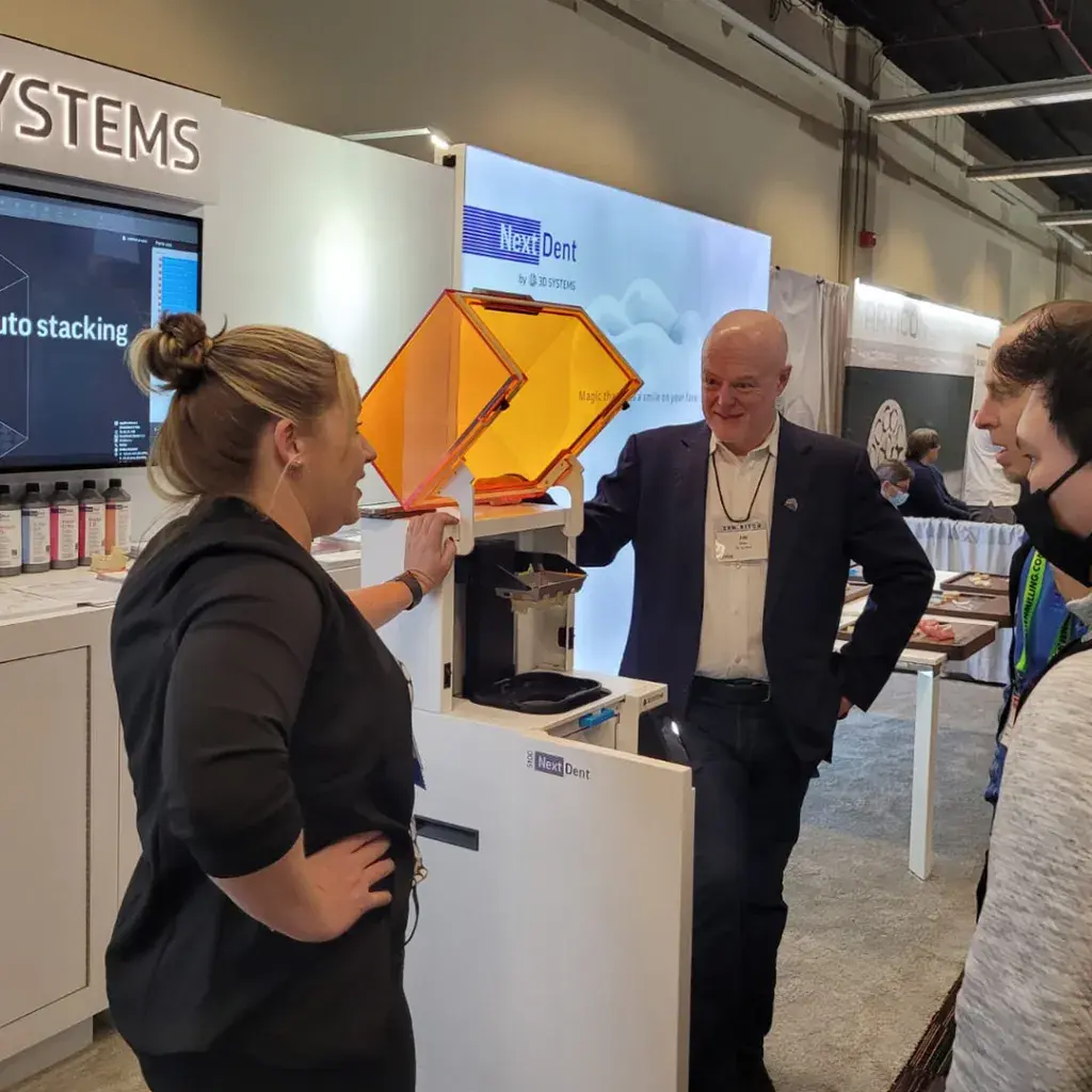 Dental Application Engineer, Adrienne Slevin and Direct Sales Manager, Jim Dier showcasing the NextDent 5100 dental printer