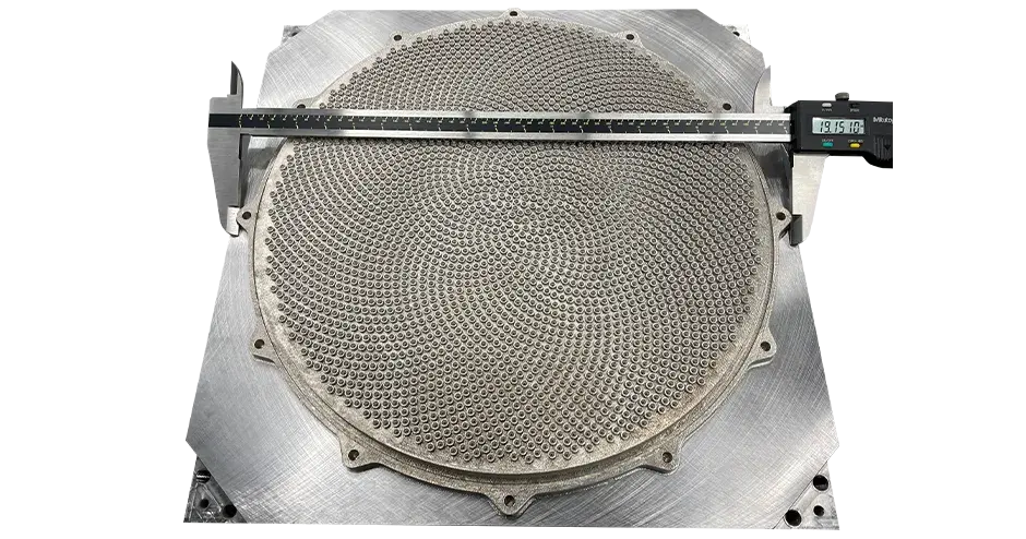 A 3D printed showerhead with a ruler on top showing the dimensions