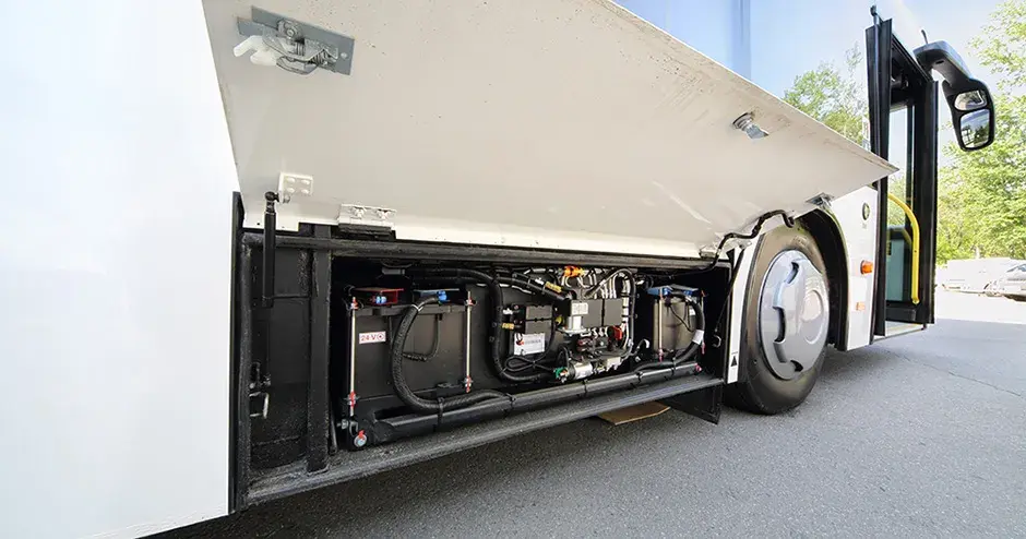 View of the compact battery and electronics compartment under an electric bus