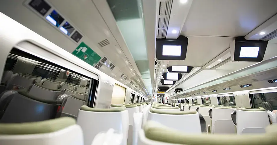 Modern and glossy interior of a passenger train showing different materials and surface finishes for different components