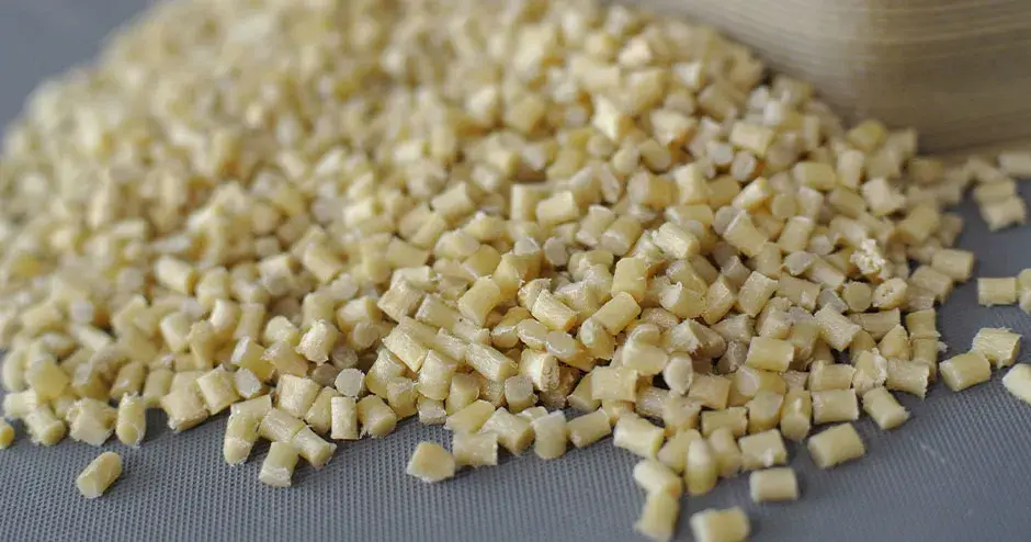 Off white plastic pellets on a grey background