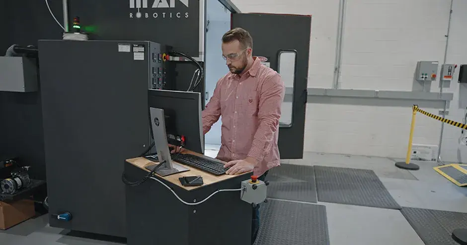 An engineer working on an Atlas H printer