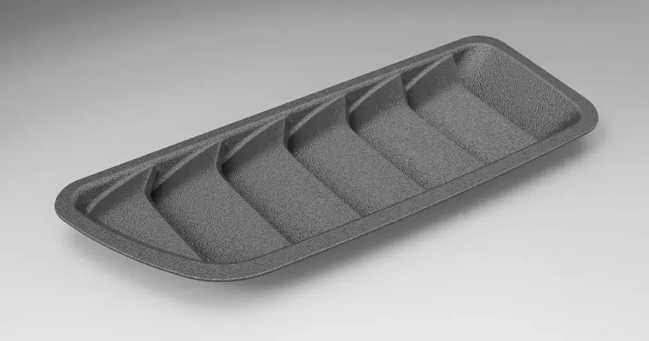 A plastic "shark" grille 3D printed with production-grade quality and a texturized surface finish.