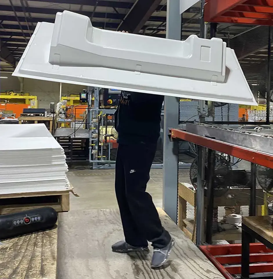 worker carrying duo form thermoform part