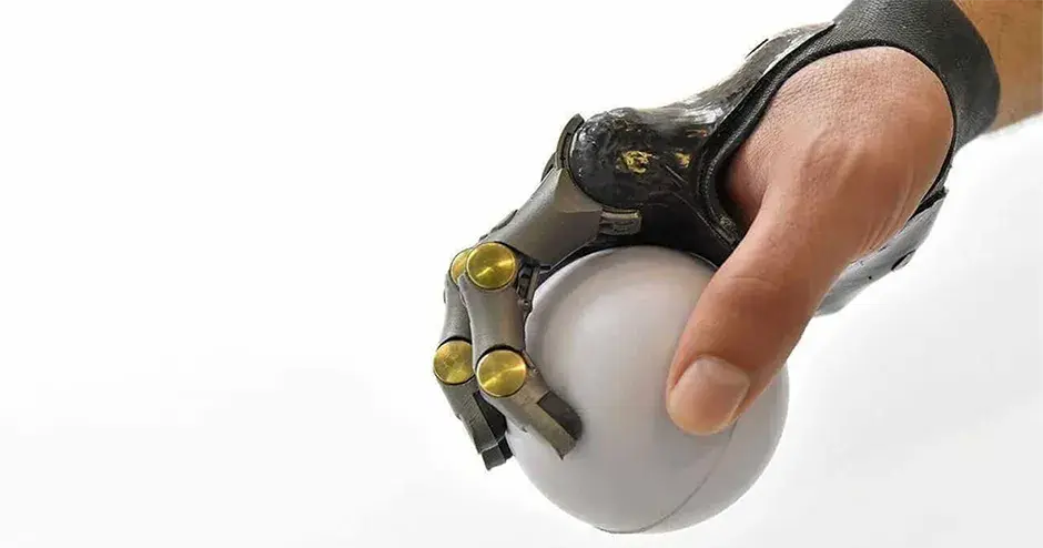 Hand with Point Designs partial prosthetic holding a white ball