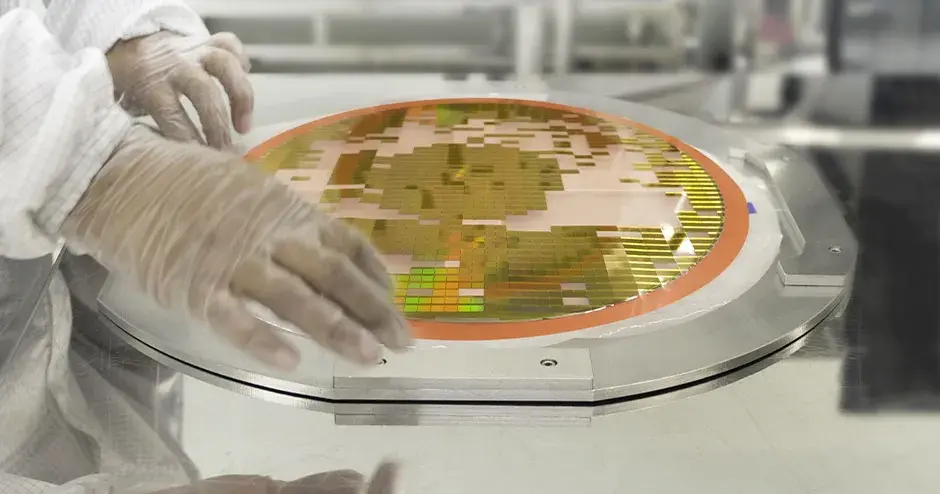 a person handling a disc with semiconductor chips