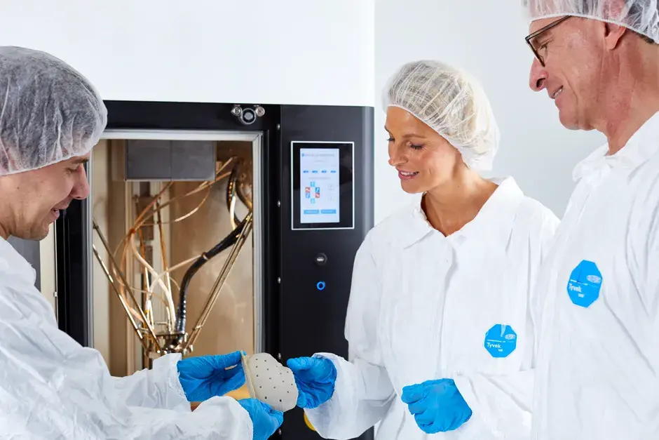 Medical experts or doctors retrieving a cranial plate from the EXT 220 MED 3D Printer