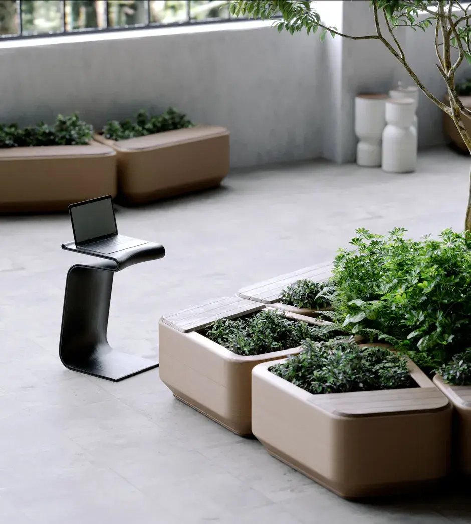 A 3D printed bench with plants growing inside of it