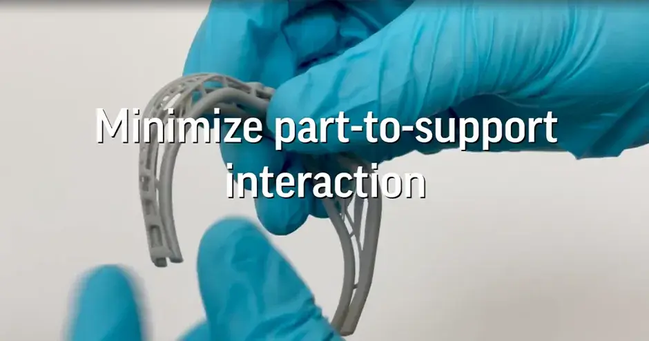 a person holding a 3D printed jewelry part