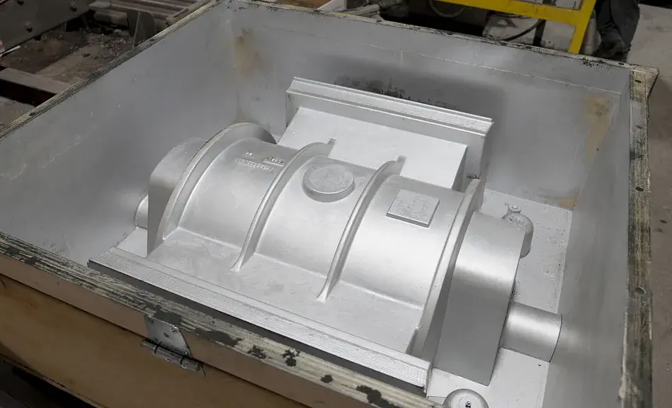 The 3D printed CF ABS pump casing pattern painted with mold release and mounted in a flask, ready to be filled with no-bake molding sand.