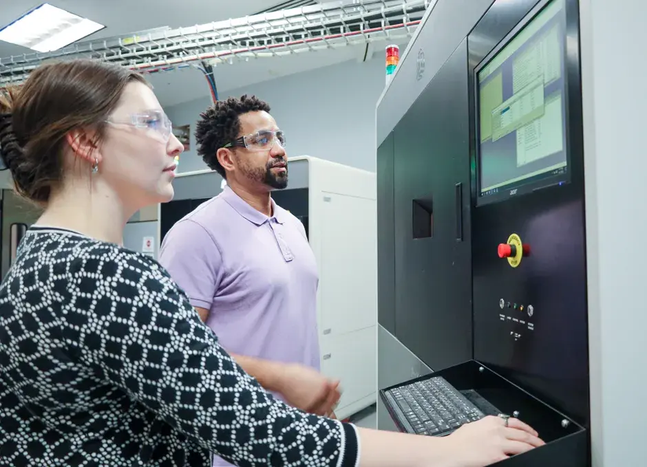 3D Systems employees at a printer