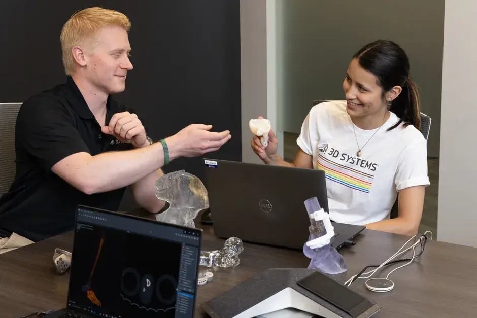 3D Systems employees at a table collaborating