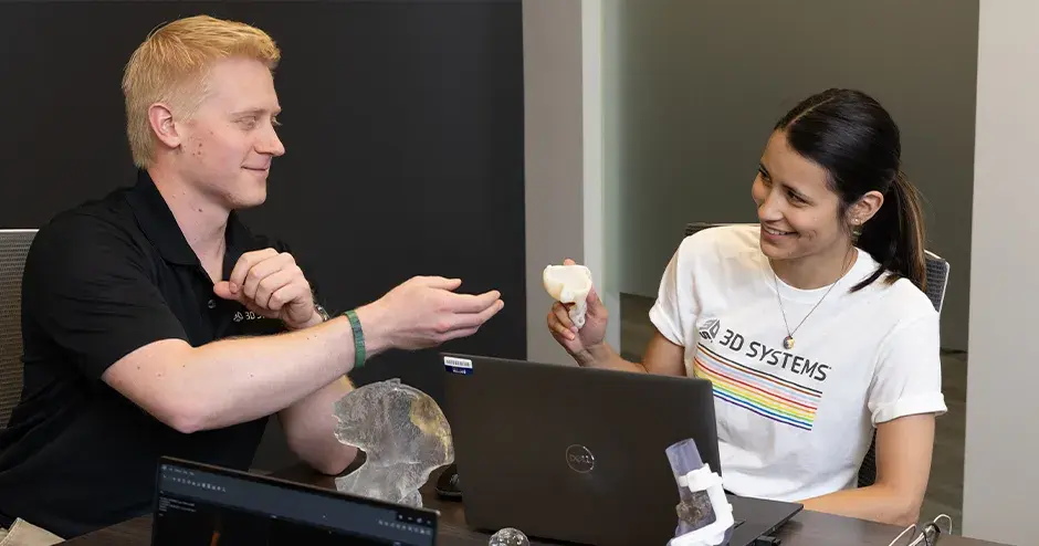 3D Systems employees collaborating at a table