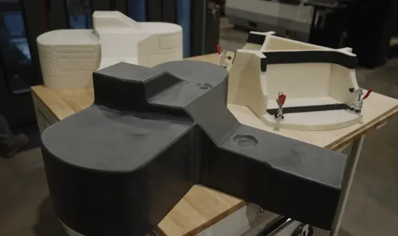 A 3Dprinted and machined CF-PC thermoforming mold, a 3D printed ABS prototype of a formed part, and a 3D printed ABS trim fixture, all produced on 3D Systems’ EXT 1270 Titan Pellet system. 