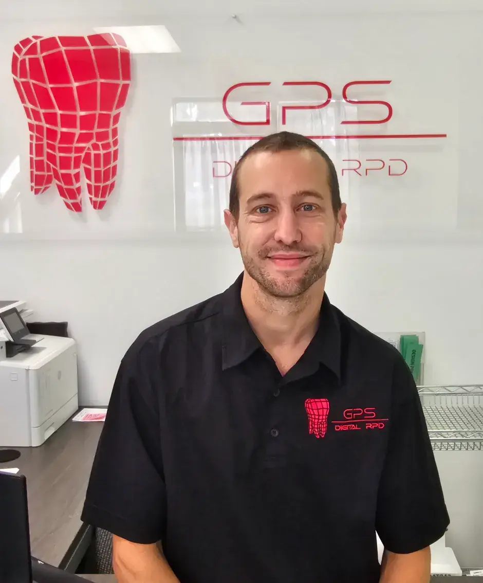 A GPS employee sitting in from of the company's logo
