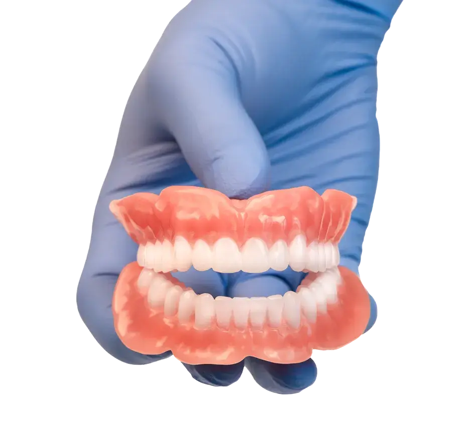 A hand with a medical glove showing 3D printed dentures