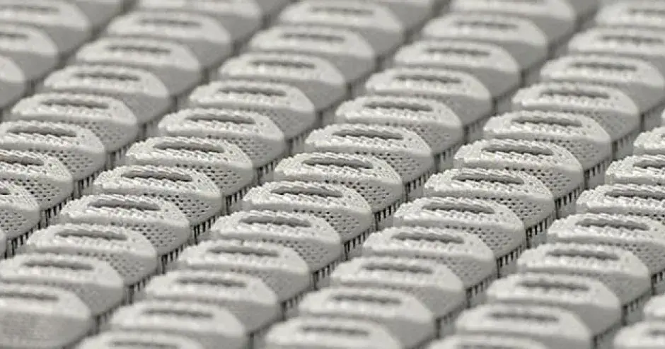 Rows of metal 3D printed spinal devices produced by rms